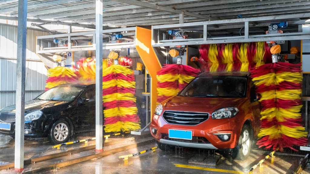 two cars coming out from a carwash