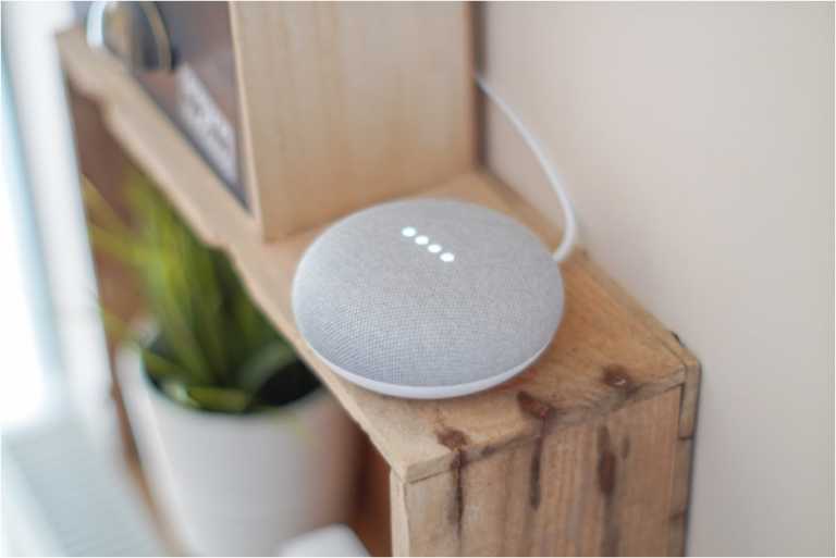 gray google home on top of table